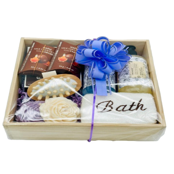 Gift basket with bath items including soap and bath products in a wooden box.