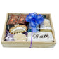 Gift basket with bath items including soap and bath products in a wooden box.
