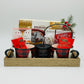 Gift basket with mugs, snacks, and a candle on a white background