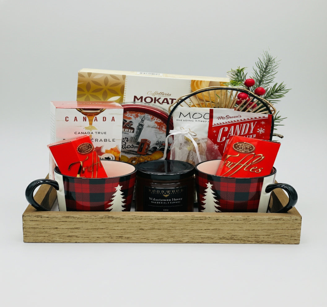 Gift basket with mugs, snacks, and a candle on a white background